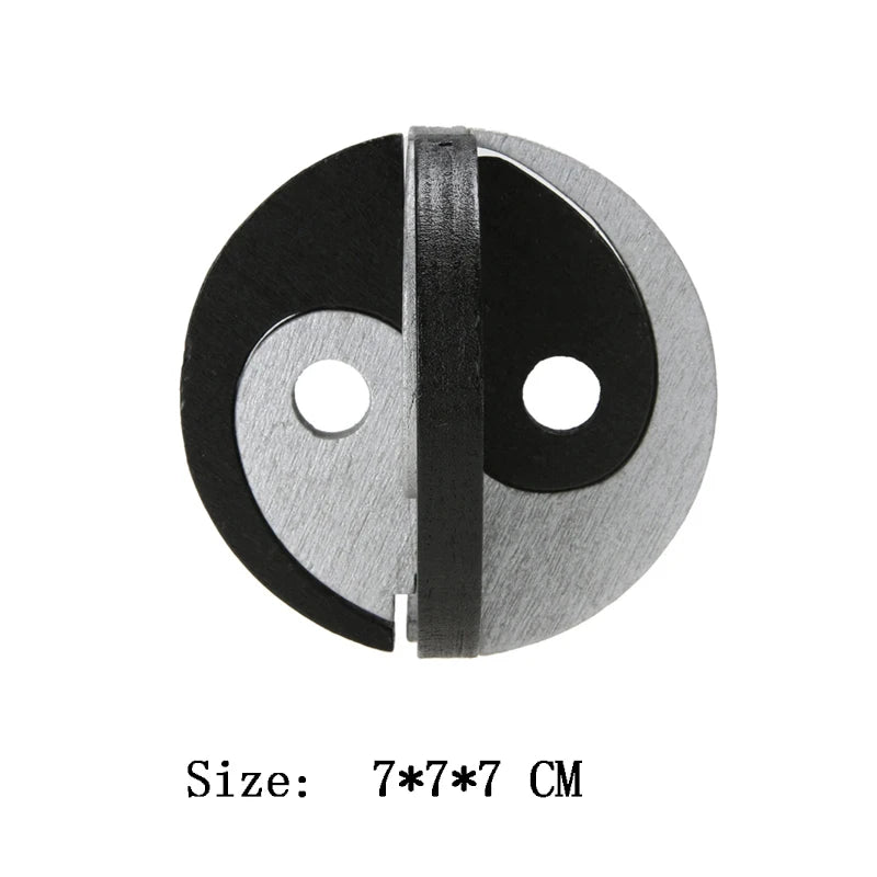 Metallic circular puzzle with two holes on a white background