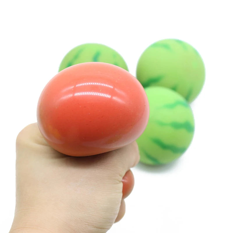 Hand holding a pink stress ball with green and pink striped balls in the background on a white background