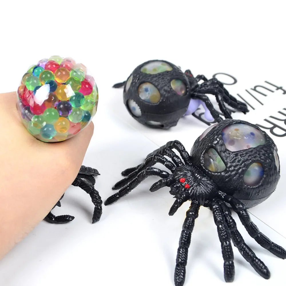Black spider toys with colorful beads on a white background