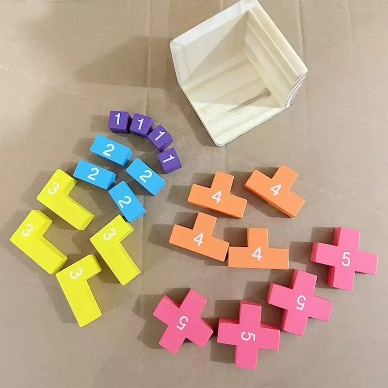 Colorful number blocks on a beige surface with a white container.